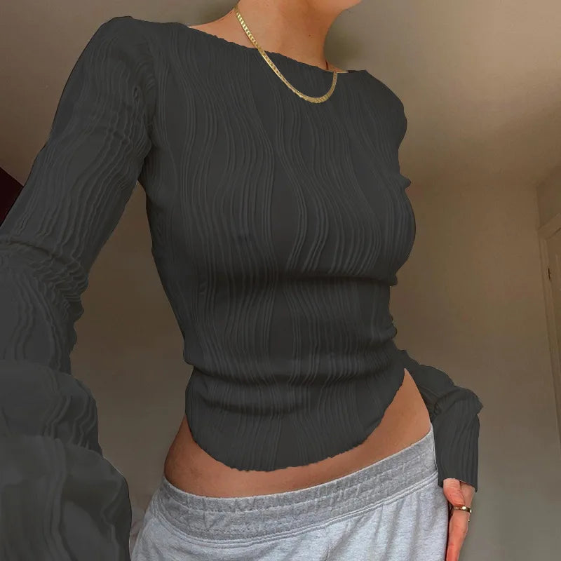 A clean, fitted crop with ruched texture and long sleeves.