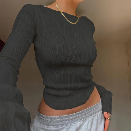 A clean, fitted crop with ruched texture and long sleeves.