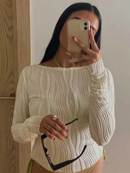 A clean, fitted crop with ruched texture and long sleeves.