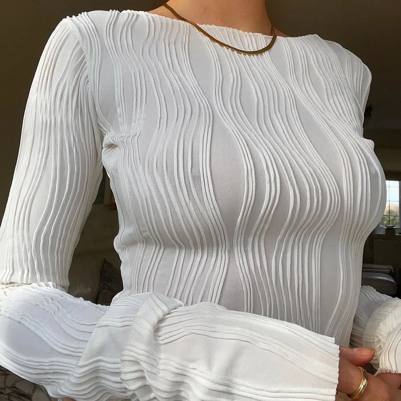 A clean, fitted crop with ruched texture and long sleeves.