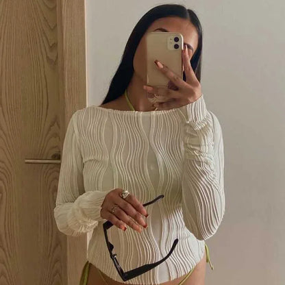 A clean, fitted crop with ruched texture and long sleeves.