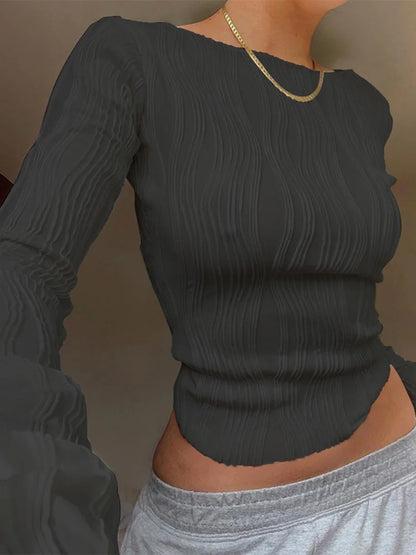 A clean, fitted crop with ruched texture and long sleeves.