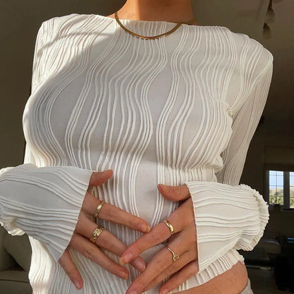 A clean, fitted crop with ruched texture and long sleeves.