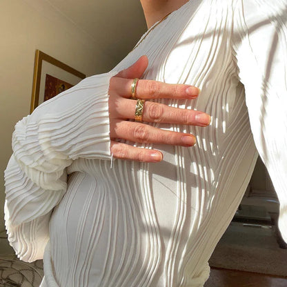 A clean, fitted crop with ruched texture and long sleeves.